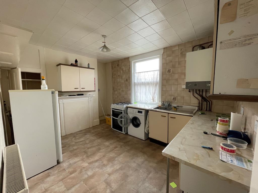 Lot: 98 - FREEHOLD BUILDING ARRANGED AS A PAIR OF MAISONETTES - Second kitchen with units and boiler